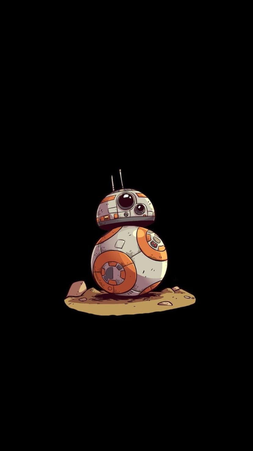 BB-8 droid with orange and white circular plating sits on sand and rocks against a solid black background.