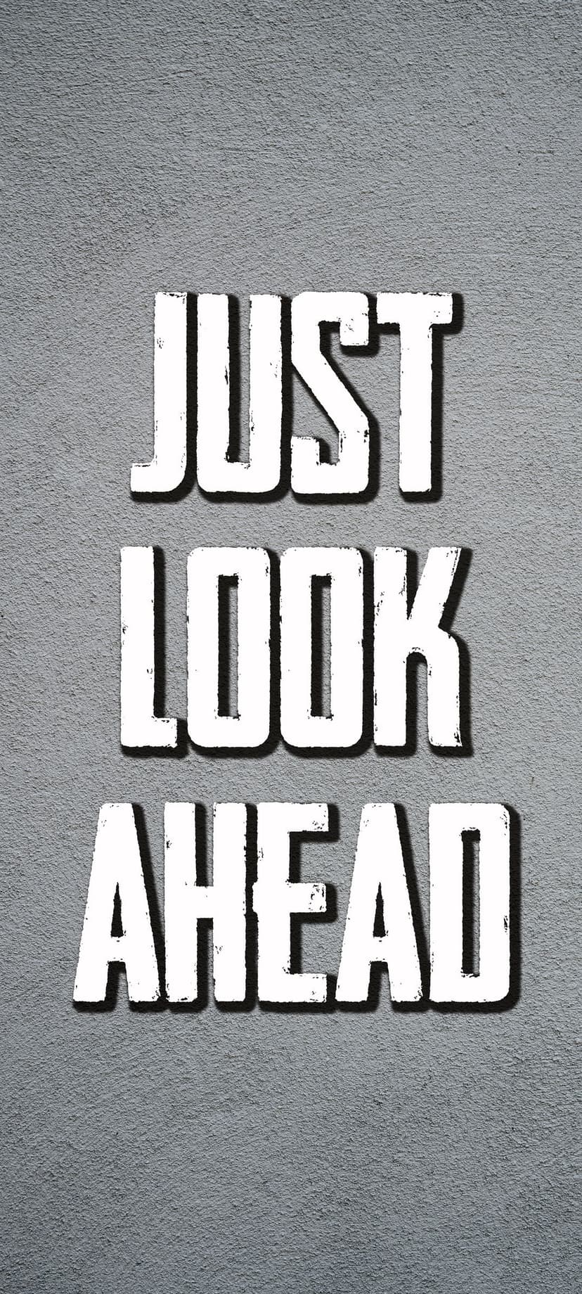 White 3D lettering spelling Just Look Ahead sits on a gritty gray textured surface with soft shadows.
