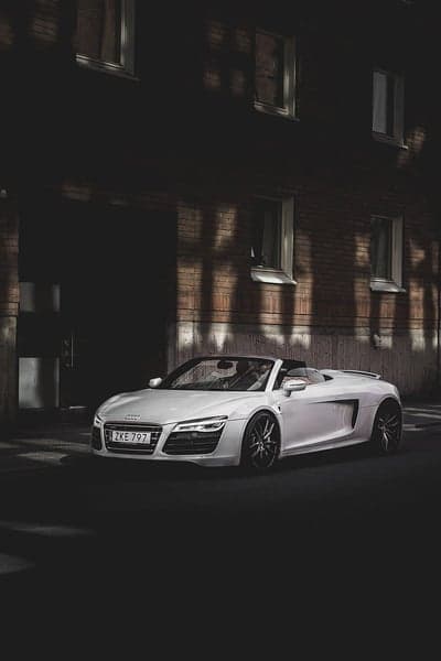 White Audi R8 Convertible parked near brick building