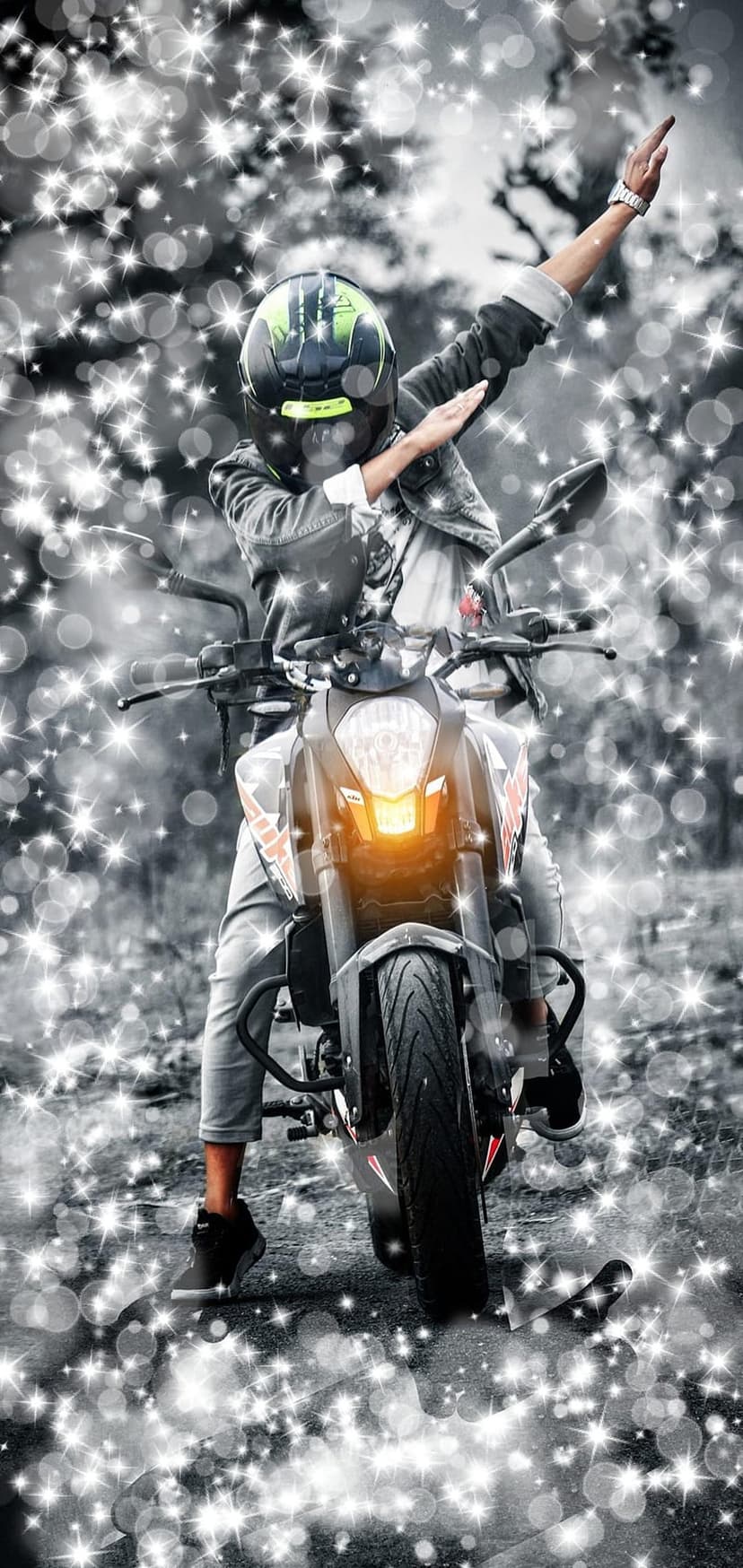 Person wearing a helmet dabbing on a motorcycle surrounded by glowing bokeh lights and orange headlight accents.