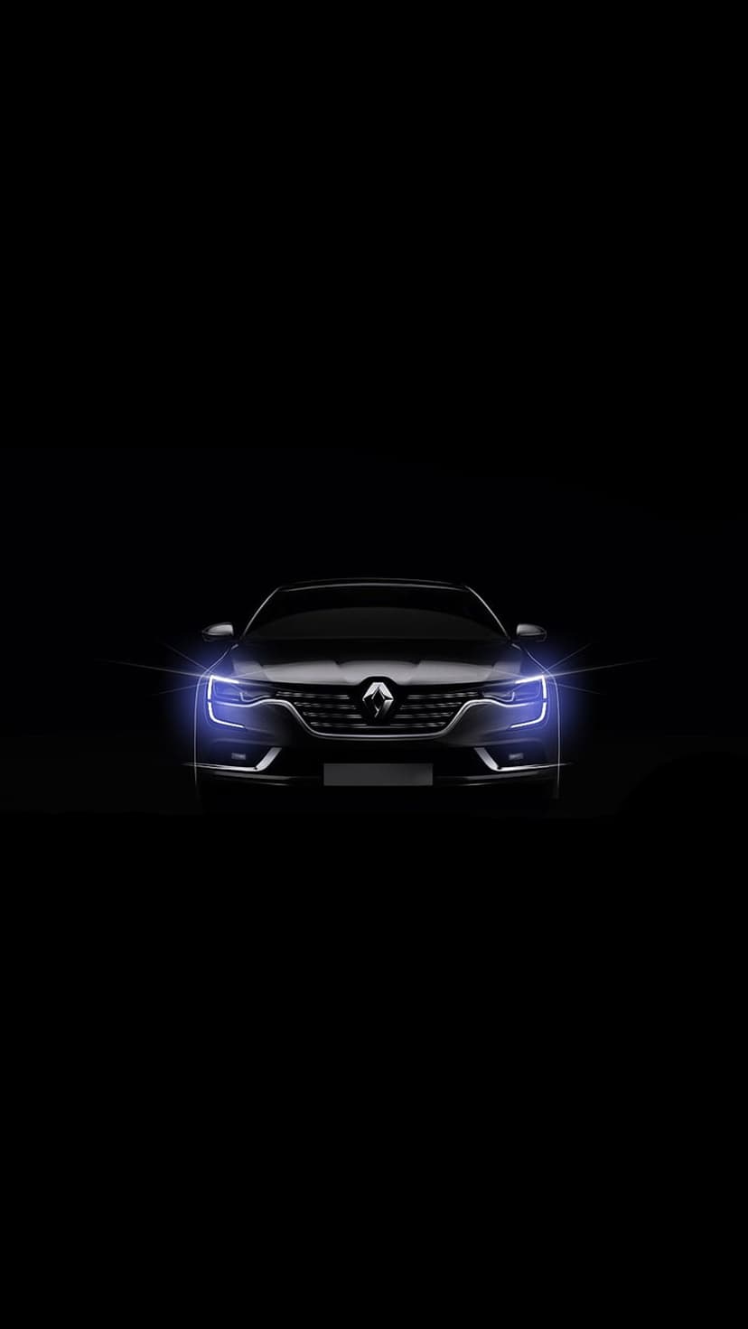 Sleek dark luxury car with glowing sapphire blue headlights against a solid black background in low light.
