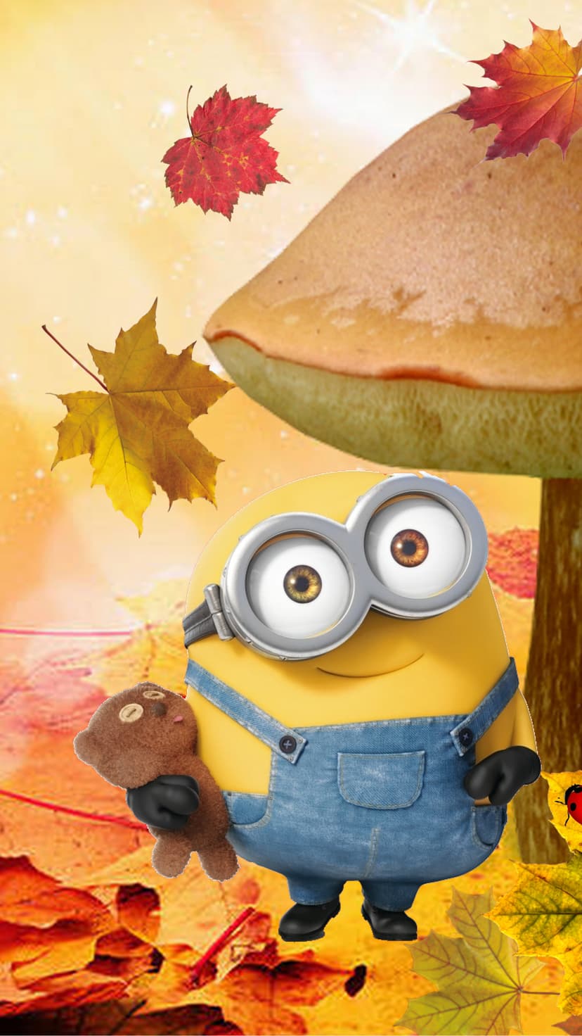 Minion wearing denim overalls holds a small brown teddy bear as red and yellow maple leaves fall around him.