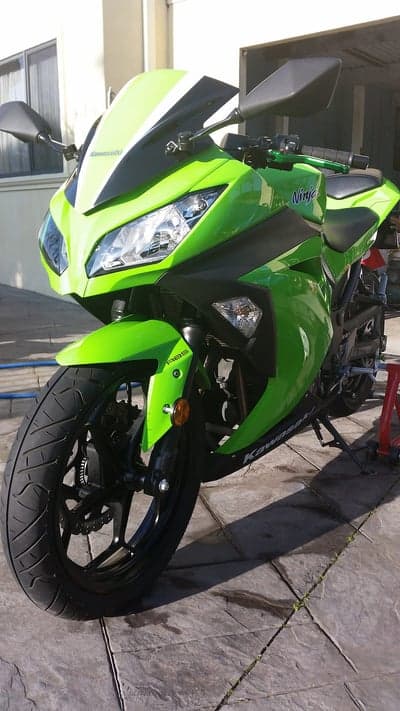 Bright Green Kawasaki Ninja Motorcycle Parked Outdoors