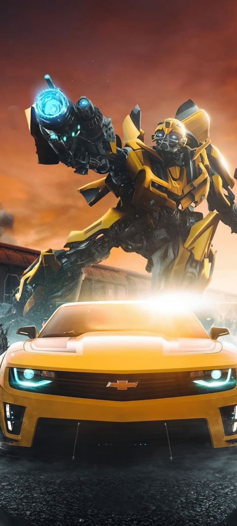 Bumblebee robot stands with a plasma cannon beside a yellow Camaro car against a burning orange sunset sky.