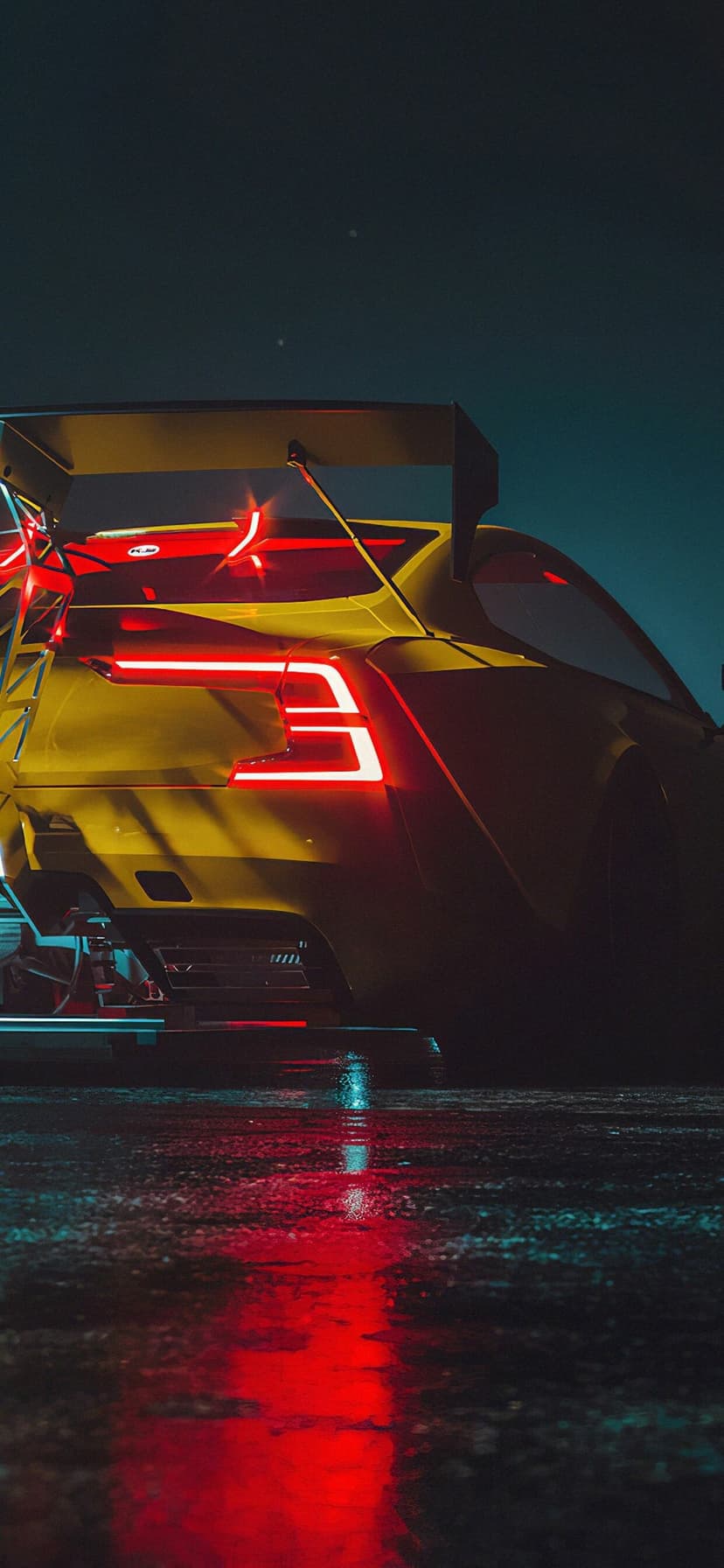 Yellow sports car rear view with glowing red LED taillights and a large wing on reflective wet ground at night.