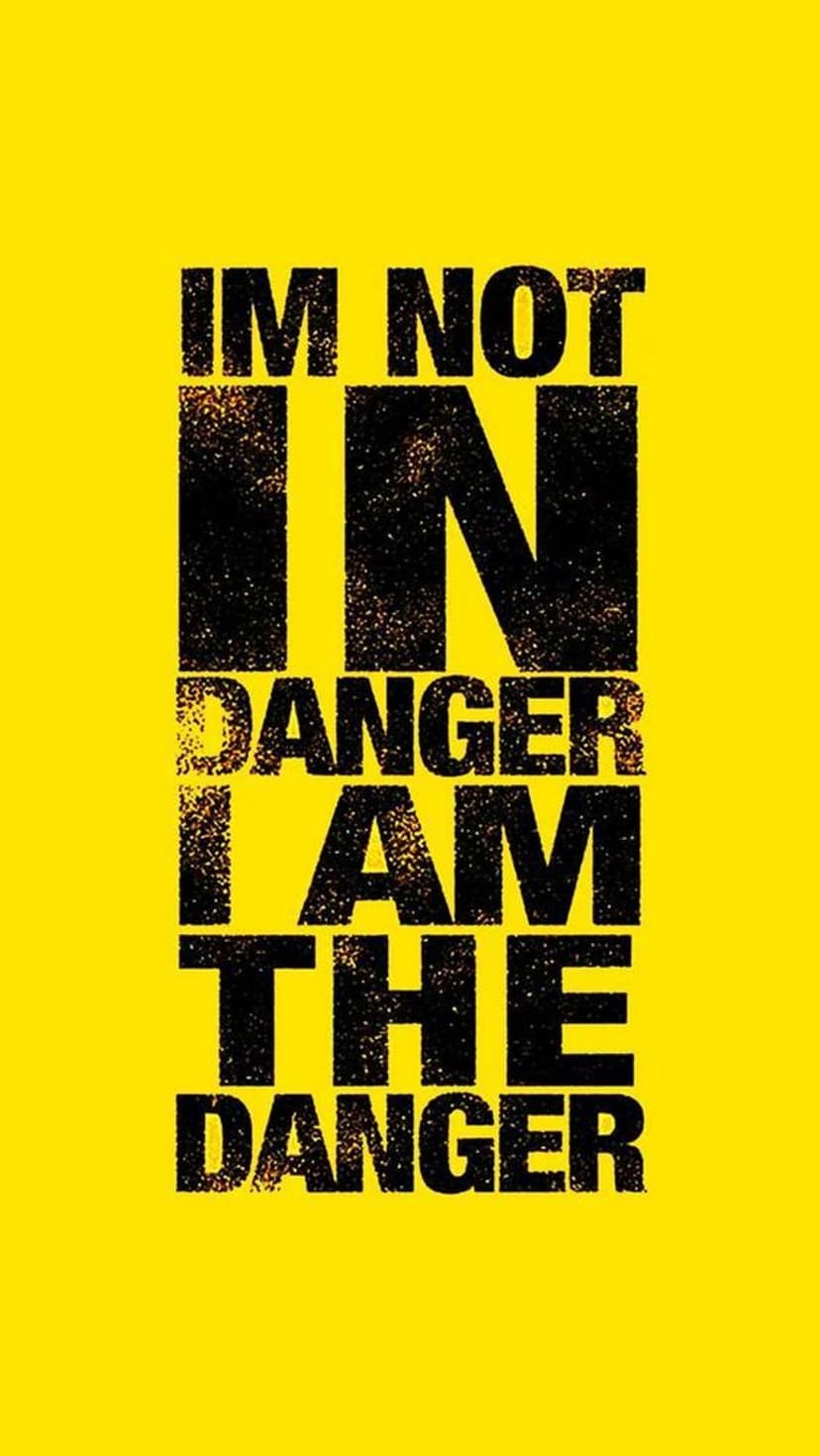 Distressed black typography reading I am the danger centered on a solid vibrant yellow vertical background.