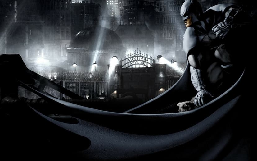 Batman crouches on a ledge overlooking the Arkham Asylum gate in a dark, foggy monochromatic night scene.