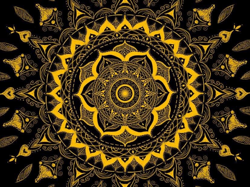 Golden sun mandala with symmetrical floral patterns and intricate line work on a dark black background.
