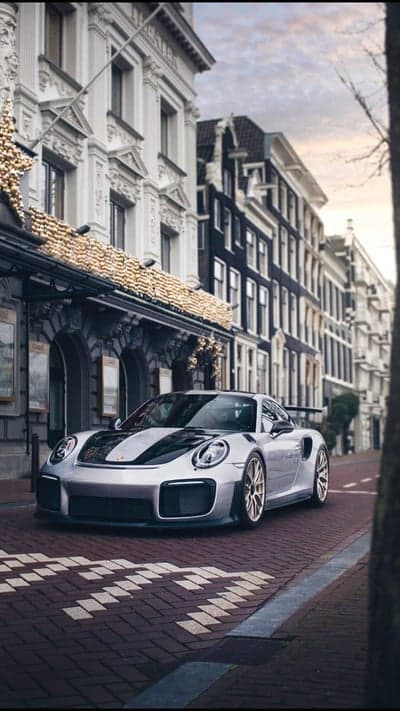 Silver Porsche GT2 RS on Amsterdam Cobblestone Street