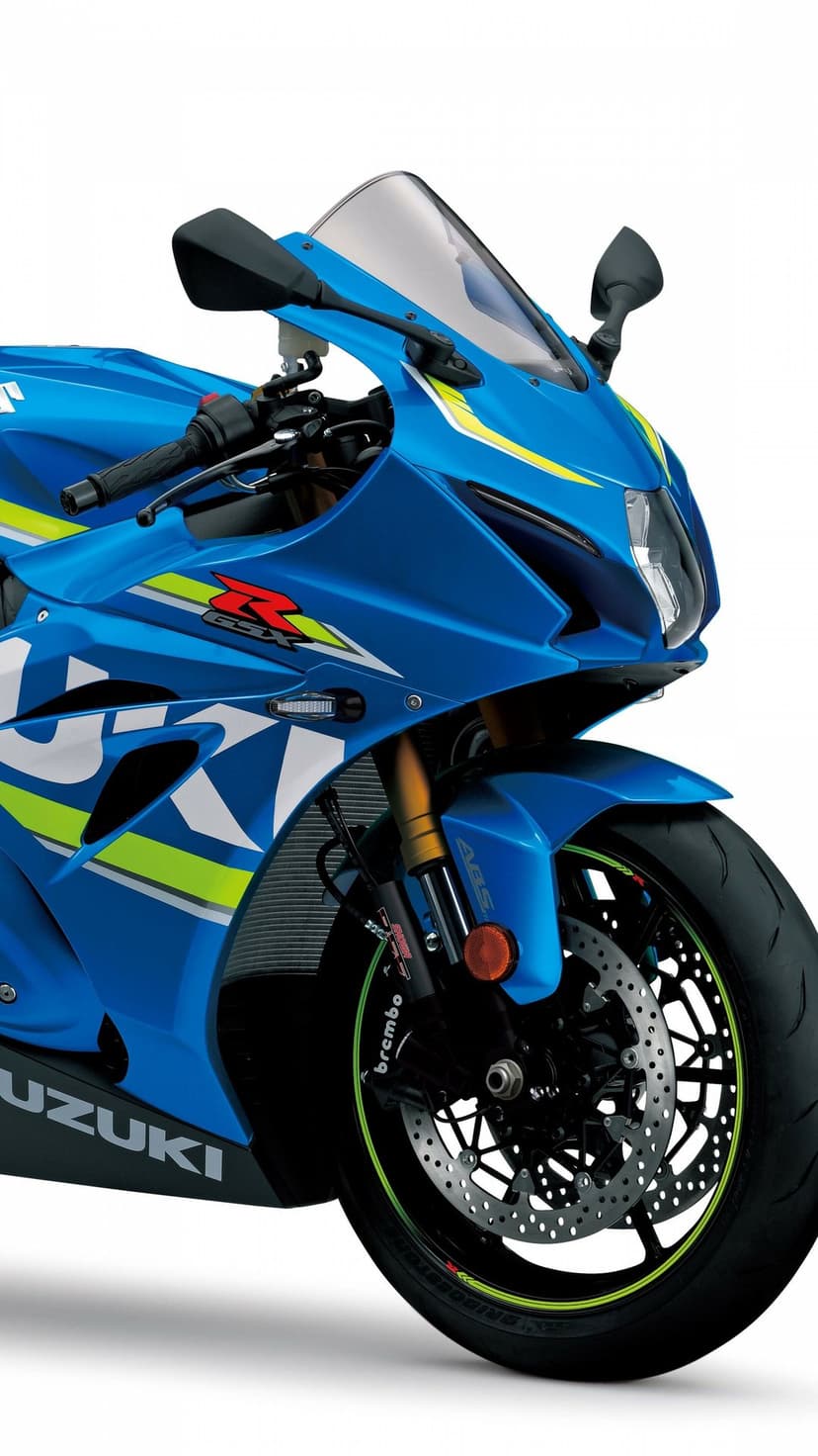 Blue Suzuki GSX-R sportbike with neon yellow accents, gold forks, and Brembo brakes on a white background.