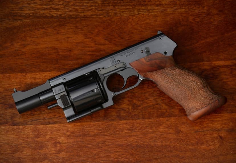 Smith & Wesson Model 500 Magnum revolver with a stainless steel frame, fluted cylinder, and dark wood handle grip.
