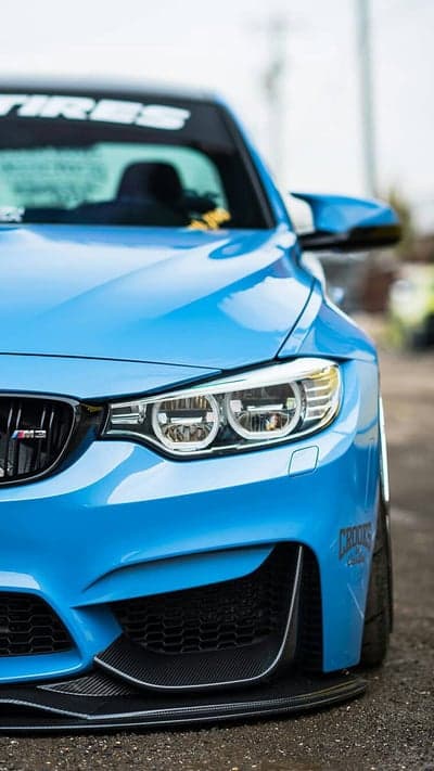 Aggressive Blue BMW M4 Coupe with Carbon Fiber Accents