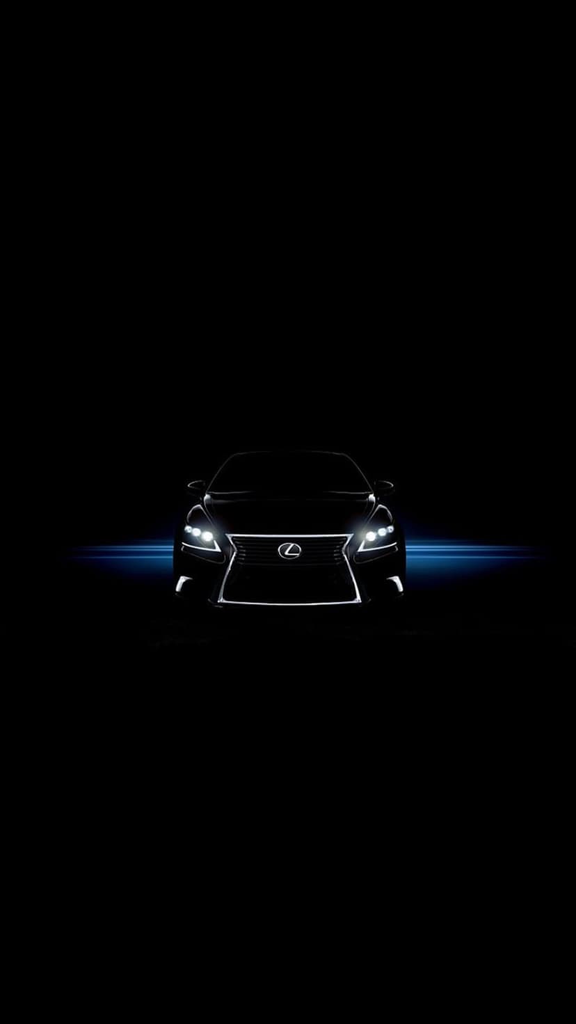 Lexus sedan front grille and LED headlights emerge from a black background with thin blue light streaks.