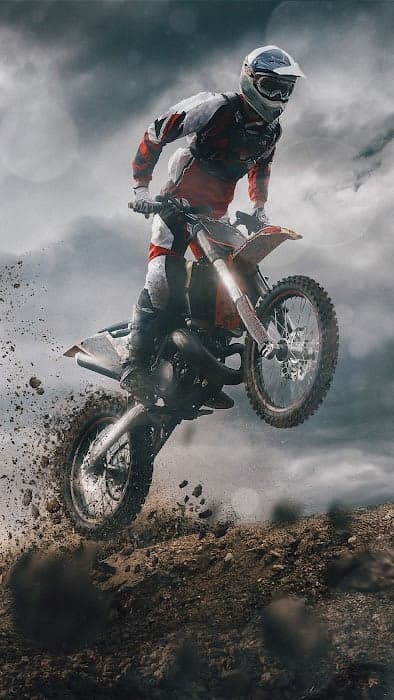Motocross Rider Jumps Dirt Track in Dramatic Action Shot
