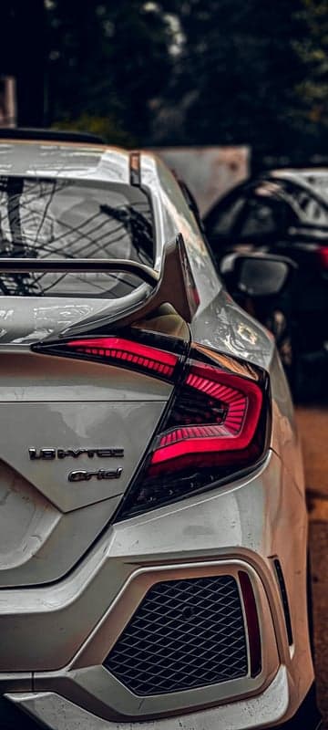 White Honda Civic with Sleek LED Taillights and Sporty Spoiler