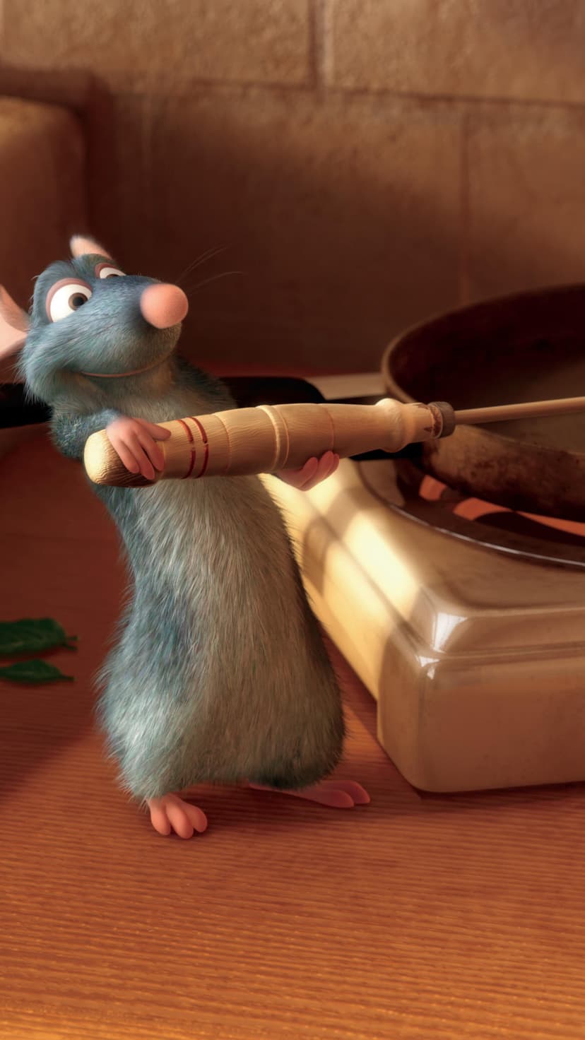 Remy the rat chef holds a metal whisk over a stove in a warm kitchen with soft lighting and copper cookware nearby.