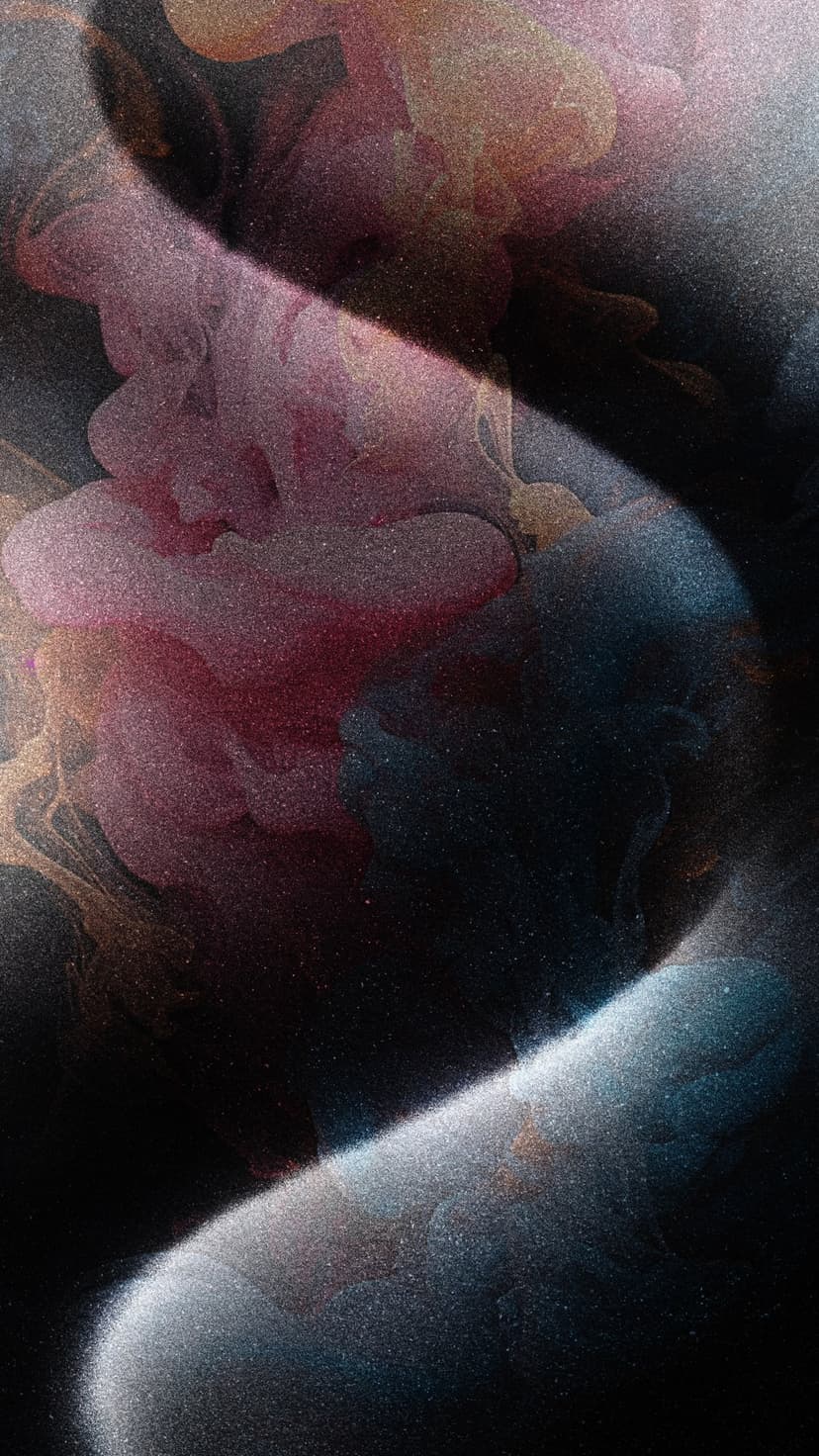 Swirling pink, blue, and gold pigments against a black backdrop create a marbleized cosmic nebula pattern.