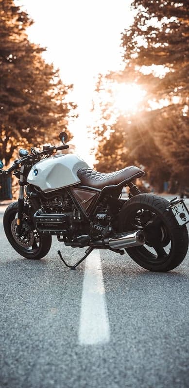 Custom BMW motorcycle bathed in golden hour sunlight