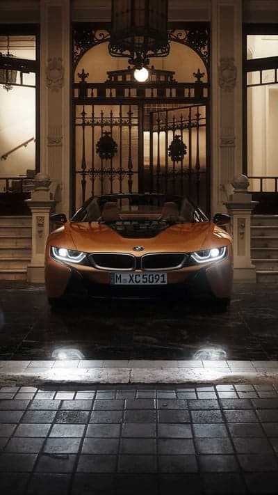 Orange BMW i8 Convertible Parked at Ornate Entrance