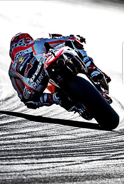MotoGP Racer Leans into a Corner at High Speed