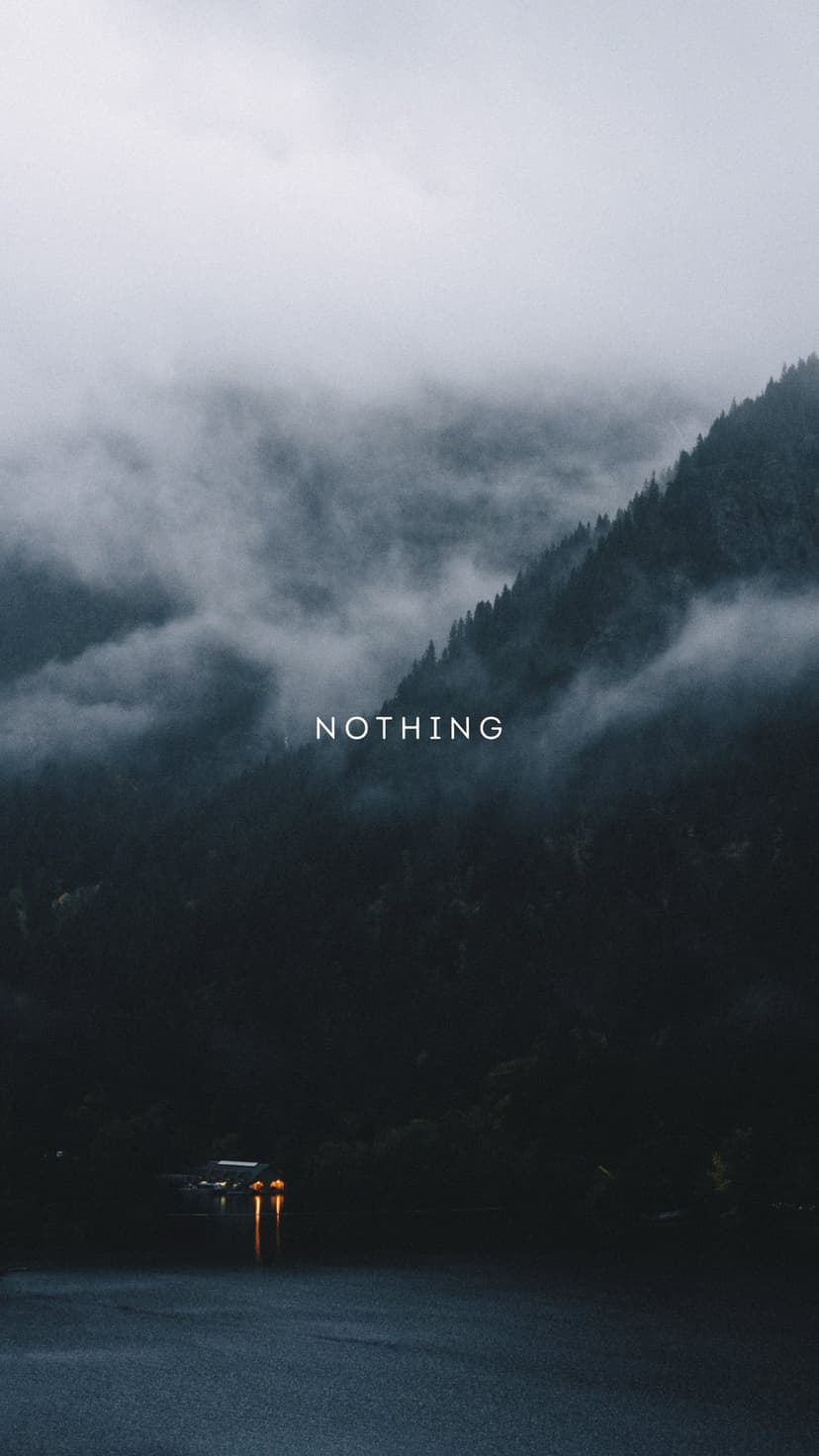 Dark mountains shrouded in fog with white NOTHING text and car headlights reflecting on a wet road surface.