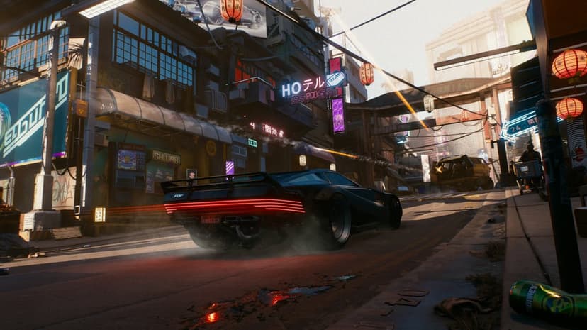 Black futuristic sports car with glowing red taillights driving through a sunlit neon city street.
