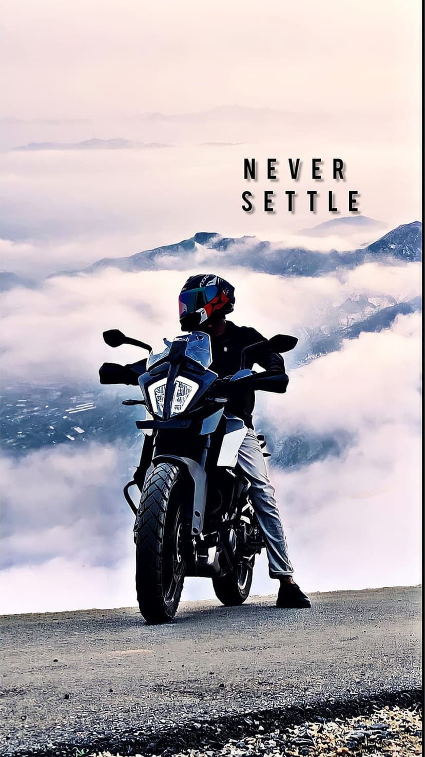 Motorcyclist on a sportbike overlooks a sea of clouds and mountain peaks with Never Settle text in the soft sky.