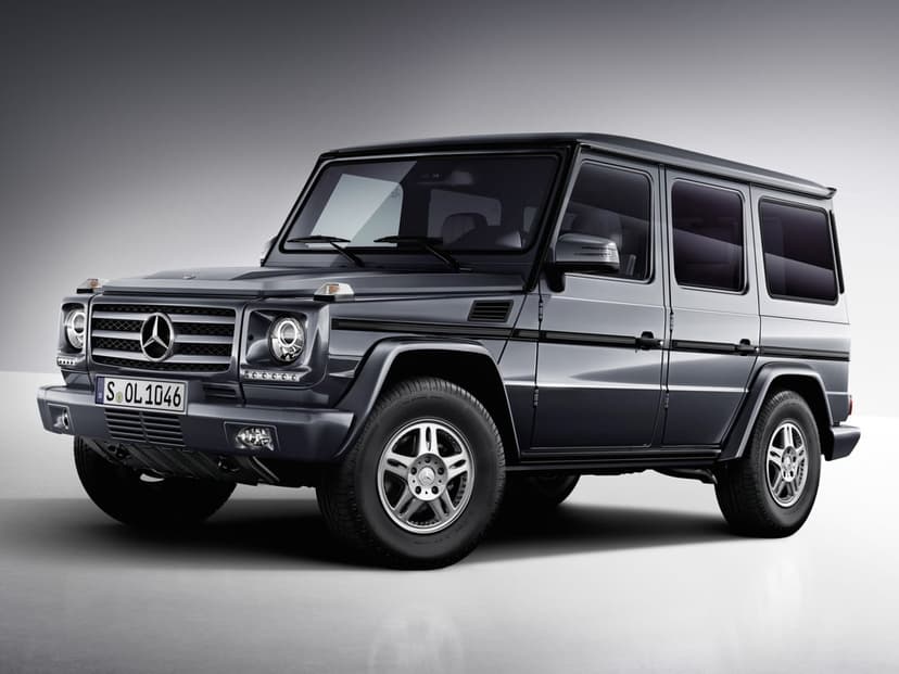 Dark grey Mercedes-Benz G-Class SUV in a studio with soft lighting and a minimalist grey background.