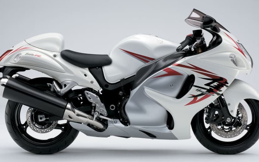 White Suzuki Hayabusa motorcycle with red accents in a side profile view against a plain white background.