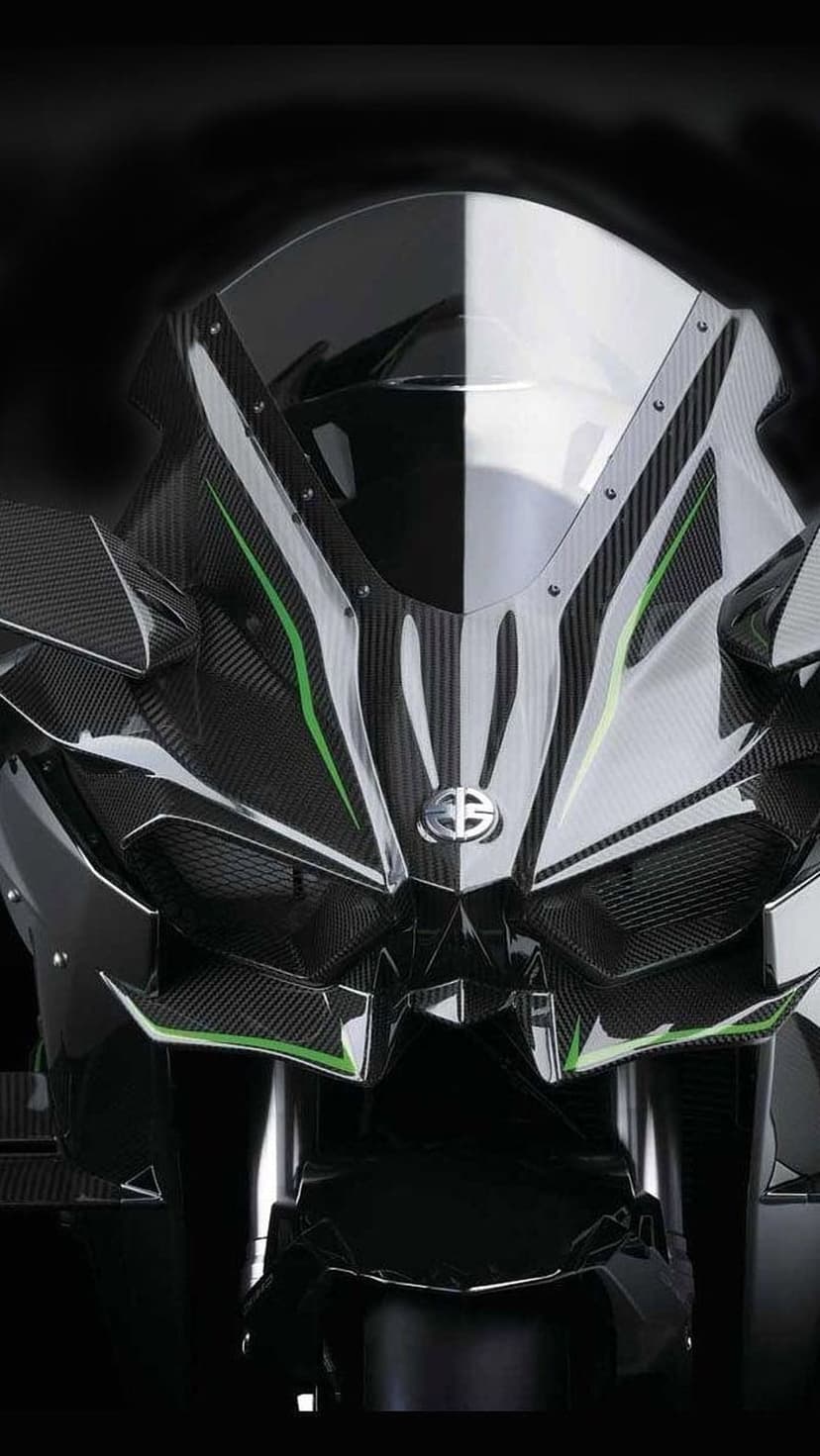 Kawasaki Ninja H2R front fairing with carbon fiber weave, aerodynamic wings, and green accents in dark lighting.