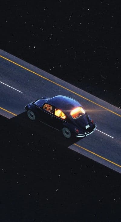 Vintage car drives on starry cosmic highway at night