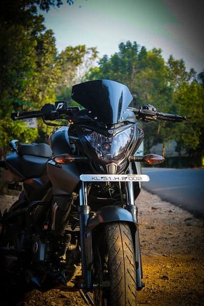 Black Sport Bike Motorcycle with Tinted Windshield on Road