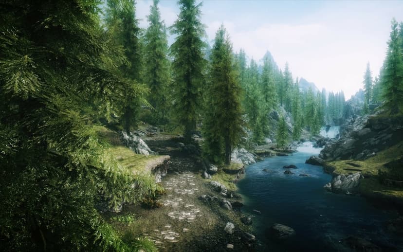 Pine forest with a stone path beside a blue river leading to a distant waterfall and mountains.