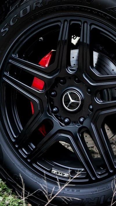 Close-up of a black Mercedes AMG wheel with red brake calipers
