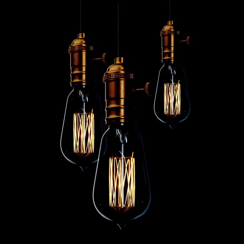 Three glowing Edison light bulbs with visible orange filaments suspended against a solid black background.