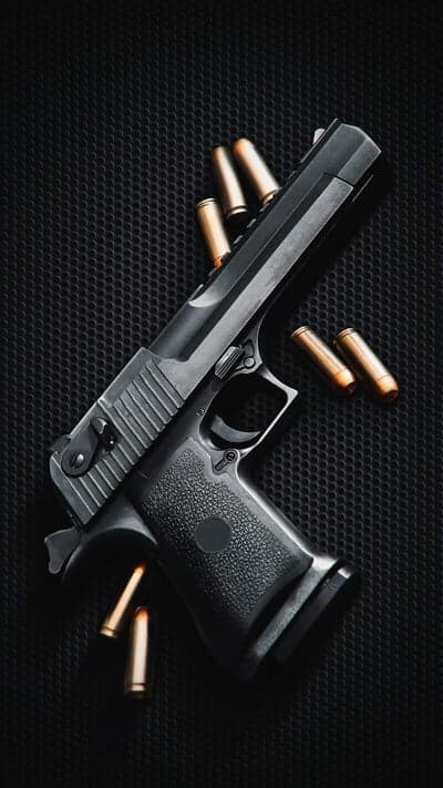 Black Handgun and Bullets on Textured Background