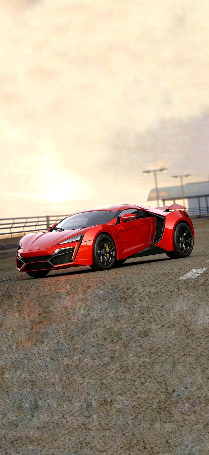 Red Lykan Hypercar with yellow brake calipers sits on a race track under a hazy golden sunset at low angle.