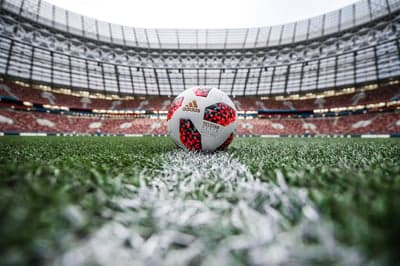 Soccer ball on stadium grass near the white line