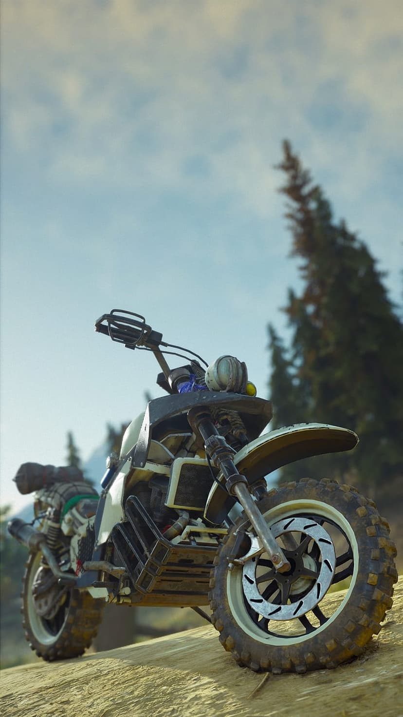 Modified dirt bike with cargo gear parked on a sandy forest incline against a backdrop of hazy pine trees.