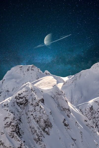 Saturn Rising Over Snowy Alpine Peaks Mobile Wallpaper