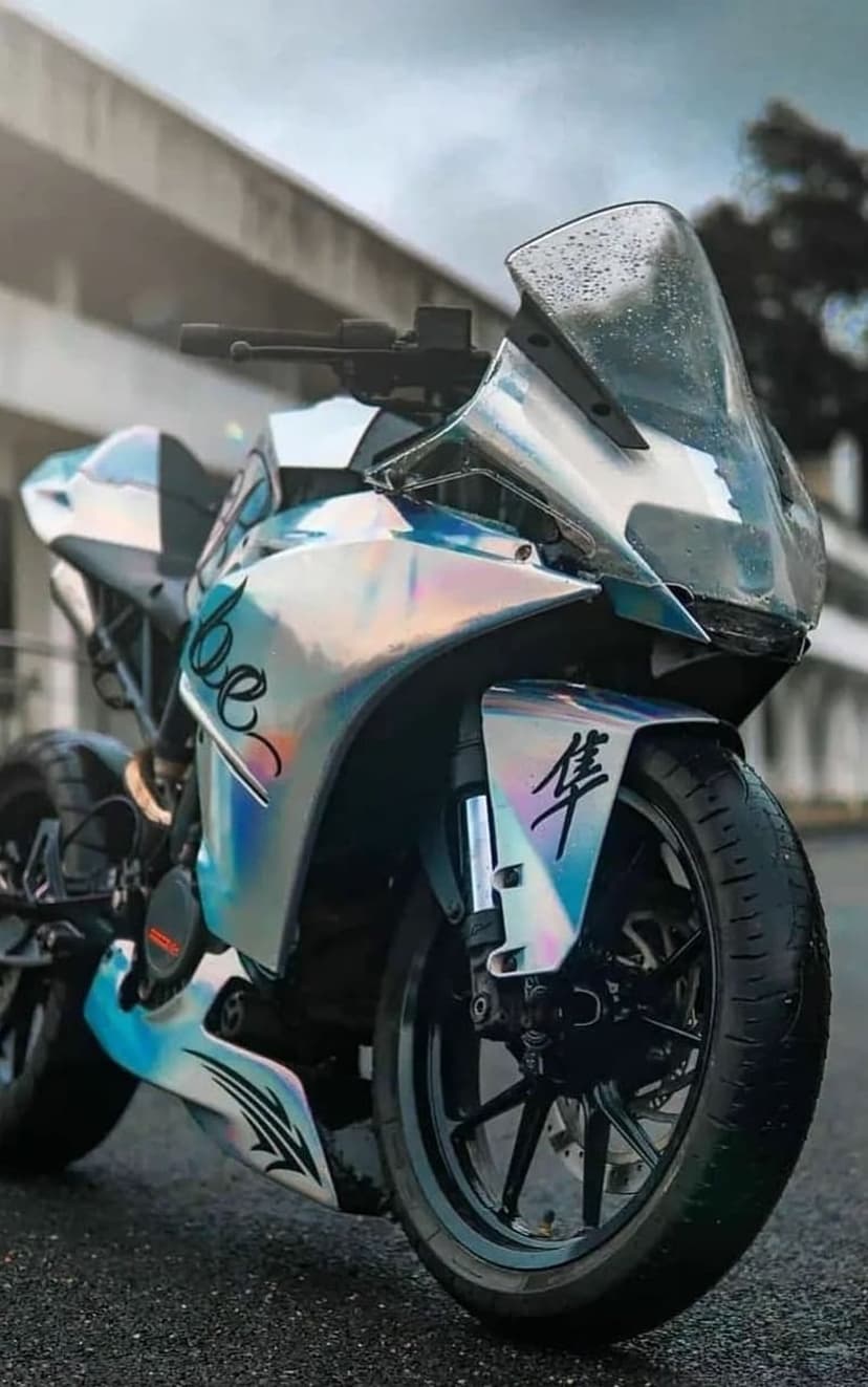 KTM sportbike with color-shifting chrome wrap and wet finish displays custom graphics and Asian characters.