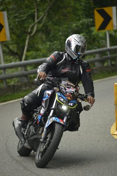 Professional Motorcyclist Leaning Into Curve Phone Backdrop