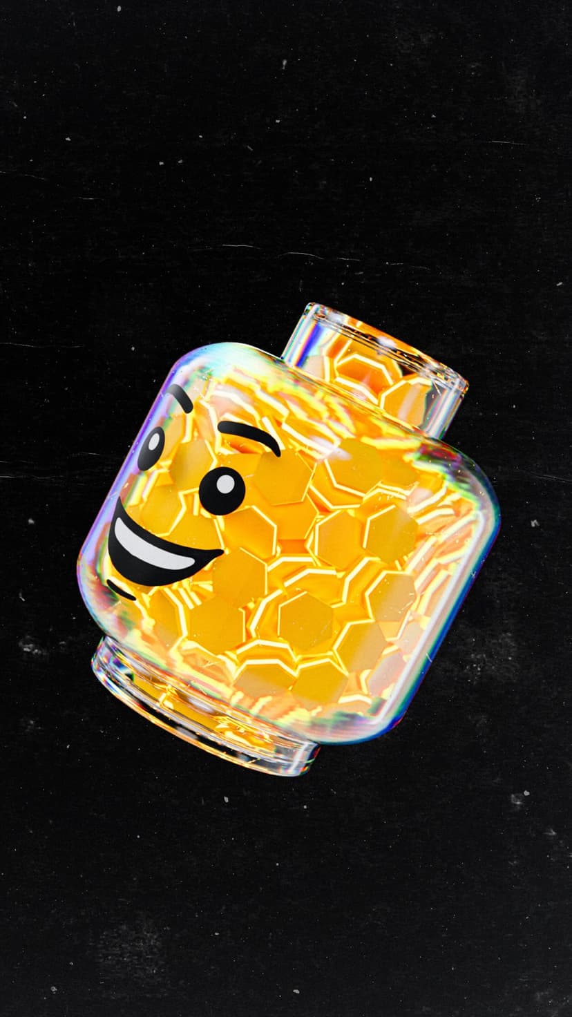 Transparent Lego head filled with yellow hexagonal glitter against a dark textured background with rainbow light.