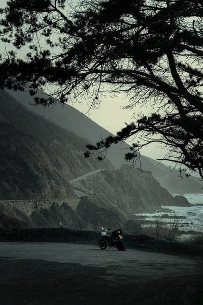 Motorcycle on coastal highway overlooking ocean