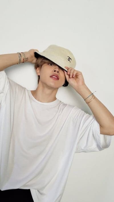 Man in bucket hat and white t-shirt posing