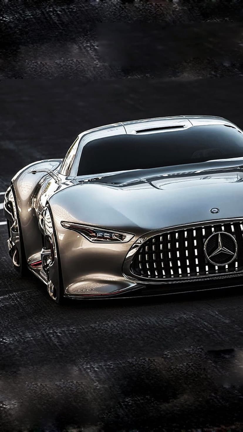 Mercedes-AMG Vision GT concept car features a silver metallic finish, bright LED headlights, and a mesh grille.