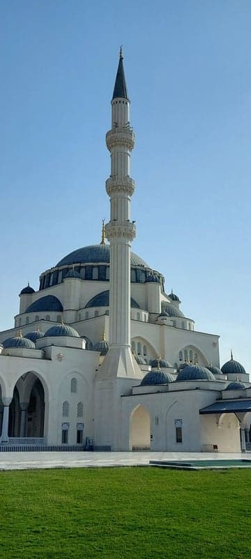 Grand Mosque with Minaret and Domes Under Blue Sky