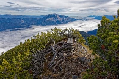 Mountain summit bench overlooking sea of clouds and peaks