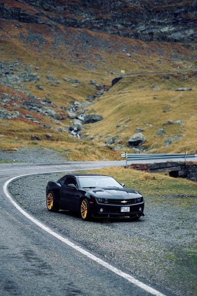 Stealth Black Camaro Mountain Road Vertical Wallpaper