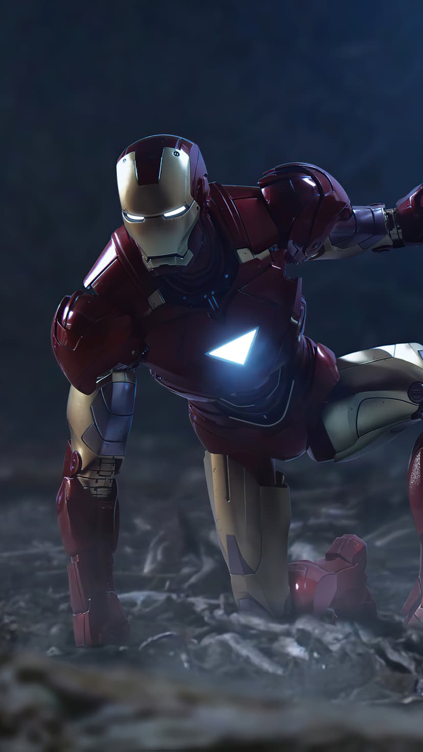 Iron Man in red armor crouches on rocky ground with a glowing triangular arc reactor and faint blue helmet eyes.